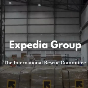 Expedia Group and The International Rescue committee over a photo of a warehouse with boxed pallets