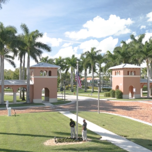 aerial view of two people by a flag pole.