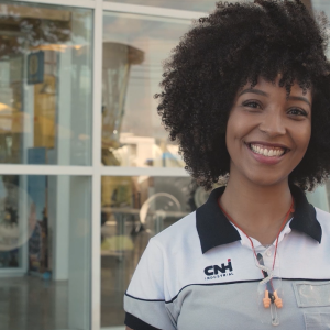 A person in CNH uniform outside a building