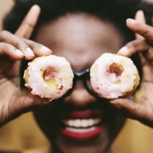 Holding two cookies as eyes