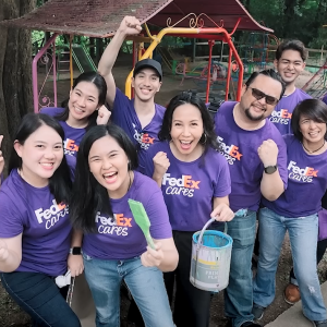 A team of volunteers, smiling to the camera.