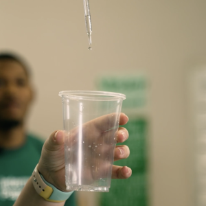 Person holding a cup of water