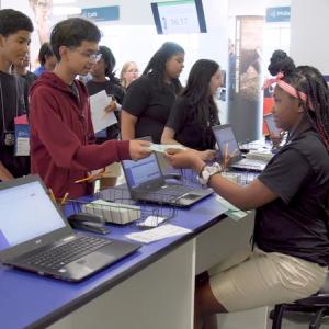 Hope Academy students shown working as bankers for the day.