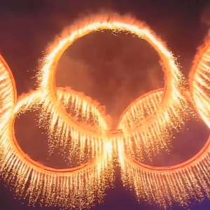 Golden sparks in the shape of the olympic rings.