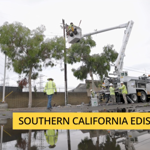 SCE crew and a bucket truck with person up high working on a line.