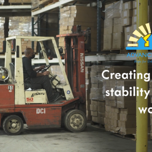 A person operating a forklift in a warehouse.