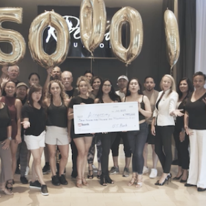 Deseo Studios receiving a $750,000 grant check from U.S. Bank.