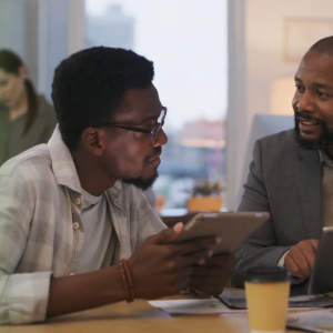 Two people sat at a desk