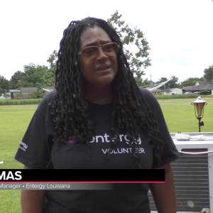 An Entergy volunteer speaks about the work the team is doing at a home.