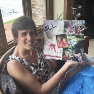 Jill Stair holding up a collage of photos