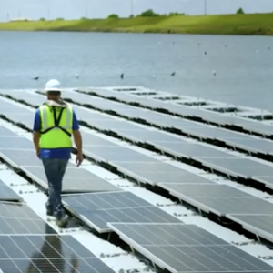 Worker walking on the floating solar array