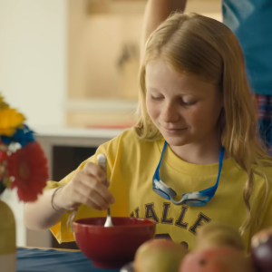 A young child sat at a dining table 