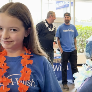 Smiling child wearing Make-A-Wish t-shirt