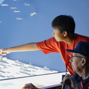 A person pointing to a military display