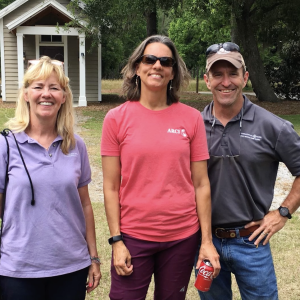 three people standing together outside