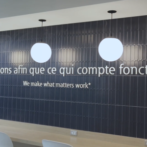Slogan on a wall in an office setting.
