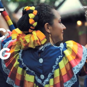 A person dancing in colorful dress. "Reflecting me" on the side.