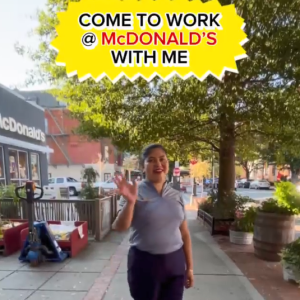 Maria Angela waving outside a McDonalds.