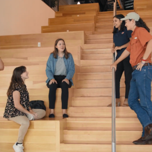 Interns in an auditorium talking casually.