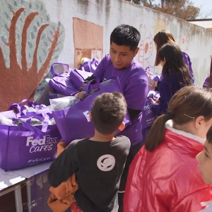 Volunteers giving bags to children