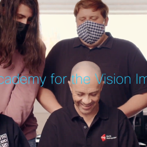 Neil and students seated around him. "Cisco Academy for the Vision Impaired".