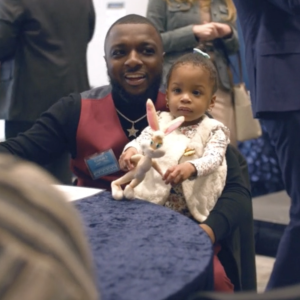 Parent holding child at table