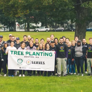 Boston DraftKings employees holding Tree Planting sign