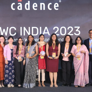 A group of people on a stage, many holding awards "CWC India 2023" behind them.