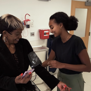 A person sat in a medical room getting their blood pressure taken