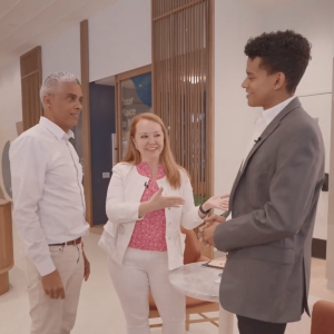A central person introducing two others in a comfortable setting.