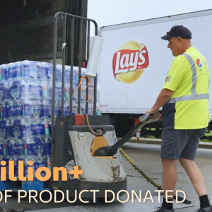 A person using a forklift to move pallets of bottled water.