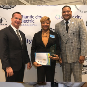 Three people stood together for a photo