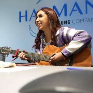 HARMAN Will: Young girl playing an acoustic guitar.