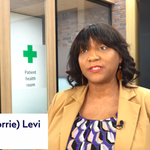 Dr. Cornetta in front of a door marked "Patient Health Room".