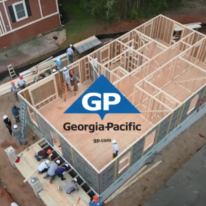 Aerial view of a home being built, many people at the site. Georgia-Pacific logo on top.