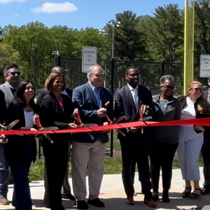 A group posed with scissors at a ribbon cutting ceremony.