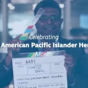 A person holding a clapboard. "Celebrating Asia American Pacific Islander Heritage" super imposed on top.