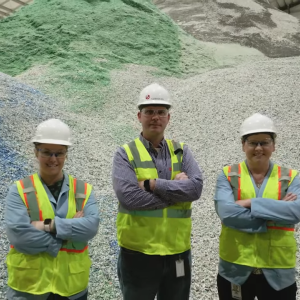 Three people stood inside a Recycling Facility
