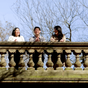 3 people standing on a bridge