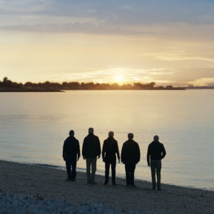 5 people on a beach at sunset
