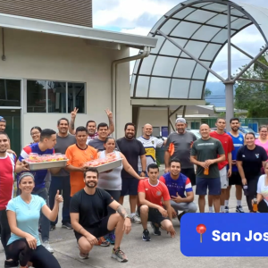 Group of employees posed outside. "San Jose, Costa Rica" in the corner.