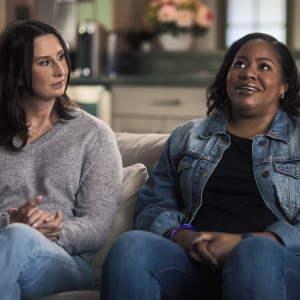 Two people seated on a couch.