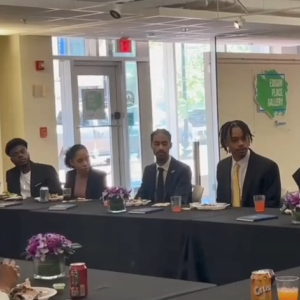 Students seated at a long table.