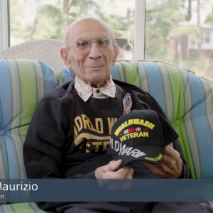 Felix Maurizio sat on a sofa holding a hat