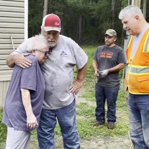 Volunteers hugging Lillian