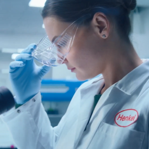 A person putting on protective eye wear in a lab setting.
