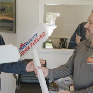 Ron Fisher, right, delivers custom signs made by Fisher Signs & Shirts.