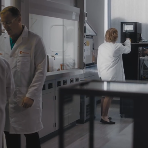People wearing white lab coats inside a data center