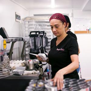 A person grabbing ingredients in a bakery setting.