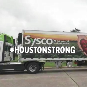"#houstonstrong" over the image of a semi-truck with Sysco logo.